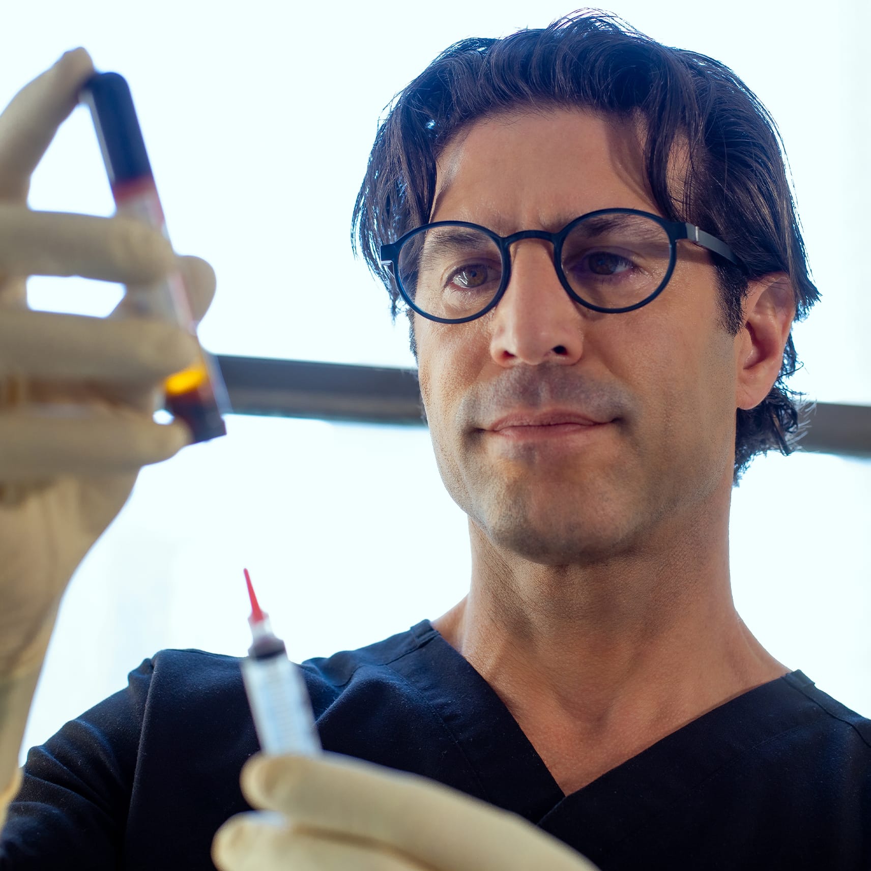 Doctor holding syringe